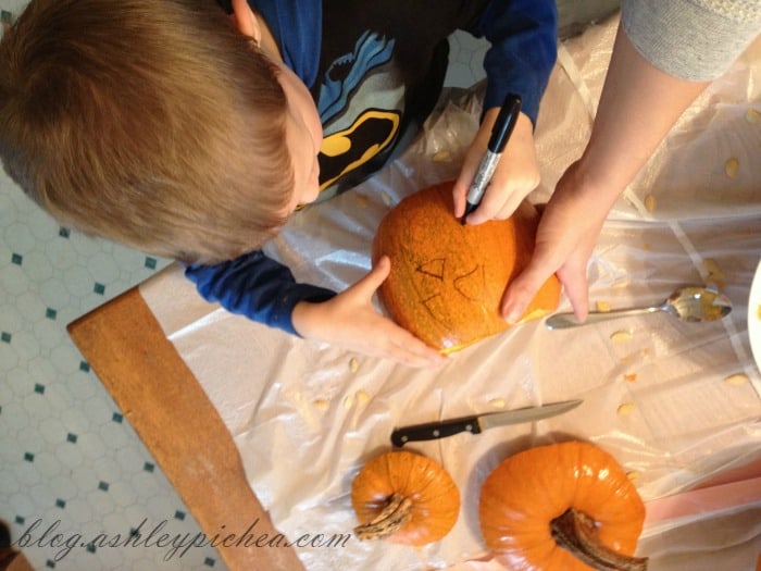 Pumpkin Carving with Kids - David drawing his pumpkin design