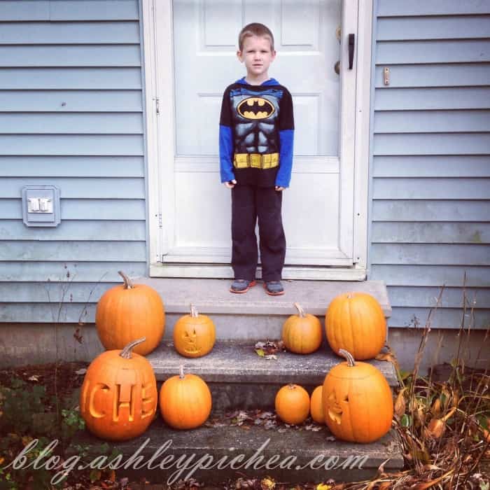 Pumpkin Carving with Kids - David with the carved pumpkins on the front porch