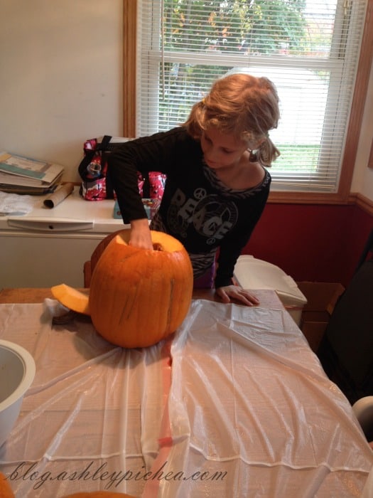 Pumpkin Carving with Kids - Jenny cleaning her pumpkin