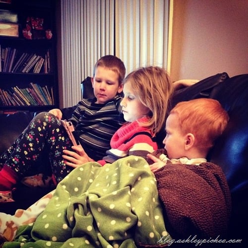 siblings watching kindle together