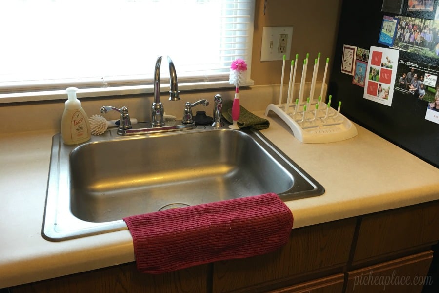 bottle brush and drying rack on counter