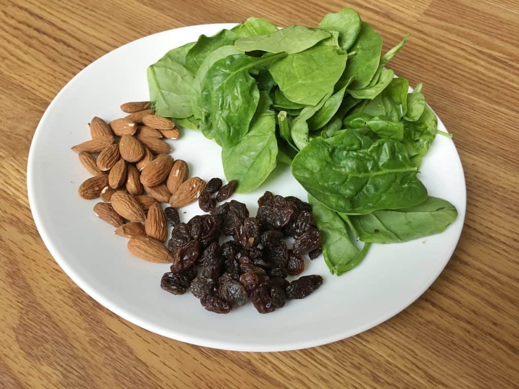 Better nutrition during pregnancy starts with eating healthy. Spinach Almond Raisin Salad is a quick and easy meal idea that you can throw together anytime of the day!