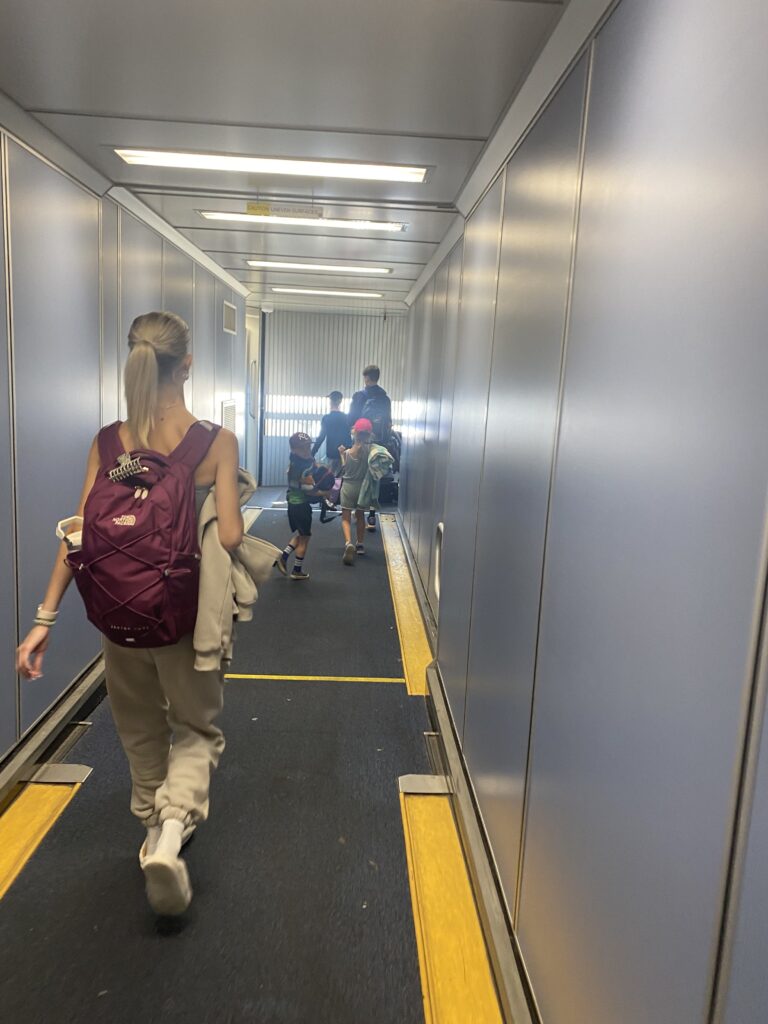 kids walking onto plane